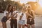 Four attractive women are standing on car parking with smartphones