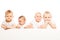 Four babies stand in a row on the white background