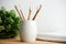 Four bamboo toothbrushes in a glass on a wooden background