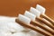 Four bamboo toothbrushes on white towel