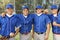 Four baseball team-mates posing on field