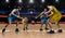 Four basketball players in game action on court