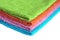 Four bath towels of different colors stacked isolated