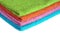 Four bath towels of different colors stacked isolated