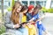 Four beautiful girls with gadgets are sitting on the bench. The concept of the Internet, social networks, study and lifestyle