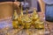 Four beautiful glossy golden vases. Gold fashionable glass vases on a marble table. Stylish luxirious interior element