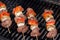Four beef kabobs on a barbecue grill