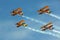 Four Biplanes Flying in Formation with Smoke