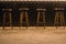 Four black bar stools with wooden legs stand near the bar in the restaurant. Scandinavian style in the interior. bar design