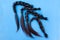 Four black chopped-off braids of human hair