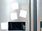 Four blank white paper notes attached on gray refrigerator door