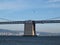 Four Blue Angels fly behind the San Francisco Bay Bridge