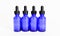 Four blue glass eyedropper bottles