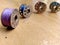 Four bobbins placed on floor and near by bobbin in focus.