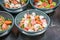 four bowls full of food sit on a table in a restaurant