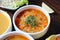 Four Bowls of Soup With Garnishes on a Table