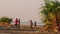 Four boys dancing on the beach at Lake Turkana
