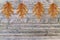 Four brown leaf on wooden board