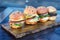 Four burgers on wooden board in restaurant