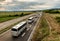 Four buses in line traveling on a highway