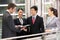 Four Business Colleagues Chatting Outside Office