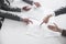 Four business people arguing and gesturing around a table during a business meeting, hands only