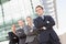 Four business people standing outdoors smiling