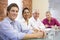 Four businesspeople in boardroom smiling