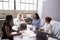 Four businesswomen in discussion in a meeting room