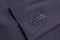 Four buttons on a black business jacket sleeve