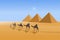 Four camel riders are hiking in the hot sun in the desert with pyramid background