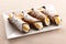 Four cannoli Sicilia with creamy ricotta filling