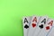 Four card ace on a green background close-up, poker square