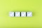 Four checkmarks on white cubes against bright green background