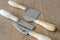 Four cheese knives on wooden background