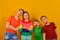 Four children with an apple in their mouths, brothers and sister in bright and colorful clothes advertise a healthy lifestyle and