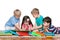 Four children with books on the floor