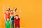 Four children in colorful clothes hold their hands up, a place for advertising text