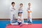 Four children demonstrate martial arts working together