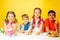 Four children holding Easter eggs at the table