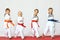 Four children in kimono hit a punch on a white background