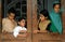 Four children look down from a window in a home in Peshawar, Pakistan