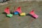 Four children's colorful ships are floating in a shallow pond. T