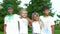 Four children standing in front of the camera and smiling in delight