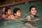 Four children swimming together