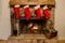 Four Christmas stockings hung by the fireplace with care.