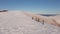 Four climbers walk on the ridge of a snowy mountain. People conquer the tops of winter mountains. Aerial view.