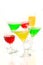 Four cocktail glasses with color drinks in the chaotic movement