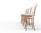 Four coffee shop chairs on white background