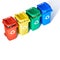 Four color coded recycle bins, isometric projection on geometric rainbow paper background with copy-space. Recycling sign on the